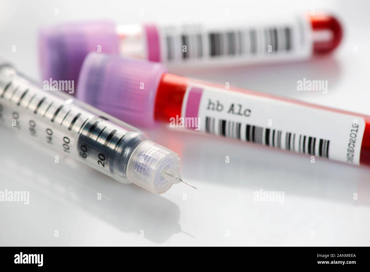 Insulin pen and hemoglobin A1c blood test tubes. The hbA1c test can asses glucose control and insulin regimen effectiveness in diabetic individuals. Stock Photo