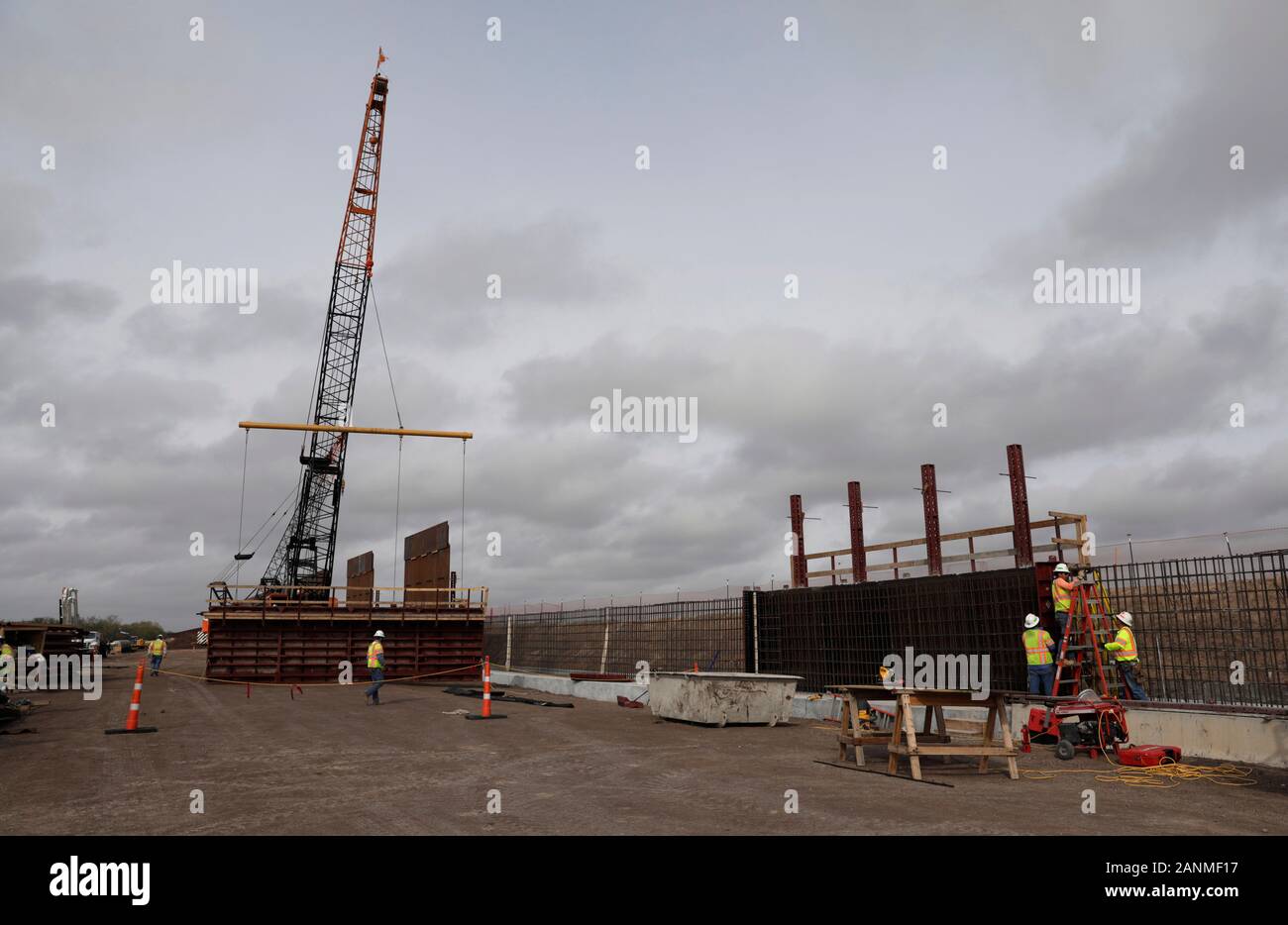 Construction crews work to erect levee wall system in a remote area south of Weslaco, Texas in