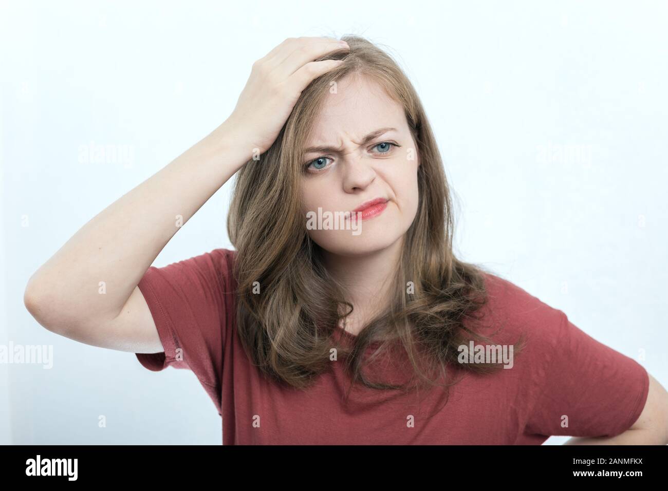 Young caucasian woman girl with puzzled, confused expression, think, forgot or remember something Stock Photo