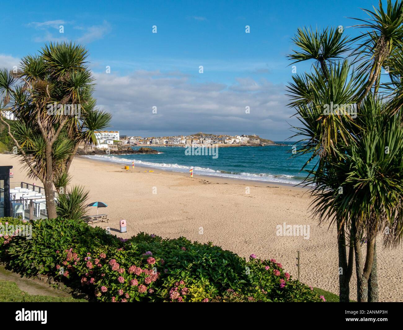Sandy Porthminster beach with the Cornish seaside town and holiday resort of St. Ives beyond on a late Summer evening, Cornwall, England, UK Stock Photo