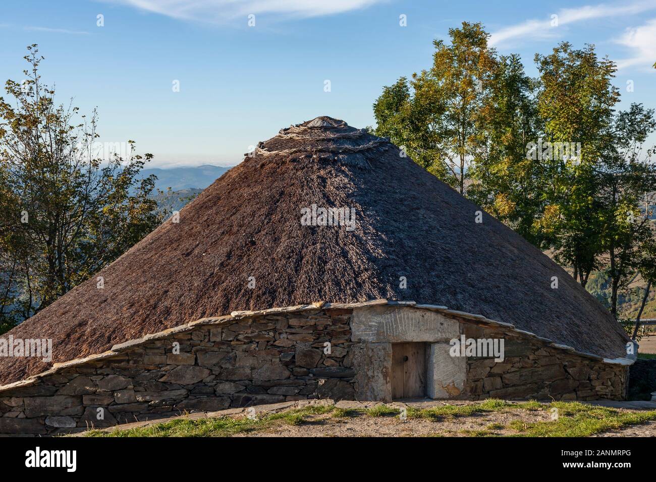 History and Drama play out in O Cebreiro Spain with historic Palloza houses and dramatic Galician Landscapes.  A stop on El Camino de Santiago, Spain. Stock Photo