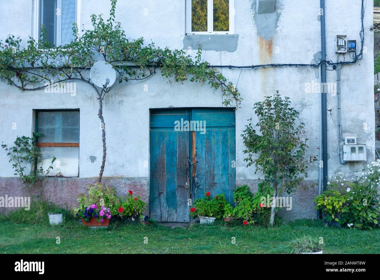 A brilliant blue door in an old Spanish house in Galicia, Spain. Technology side by side by side with tradition on El Camino de Santiago Compostela. Stock Photo