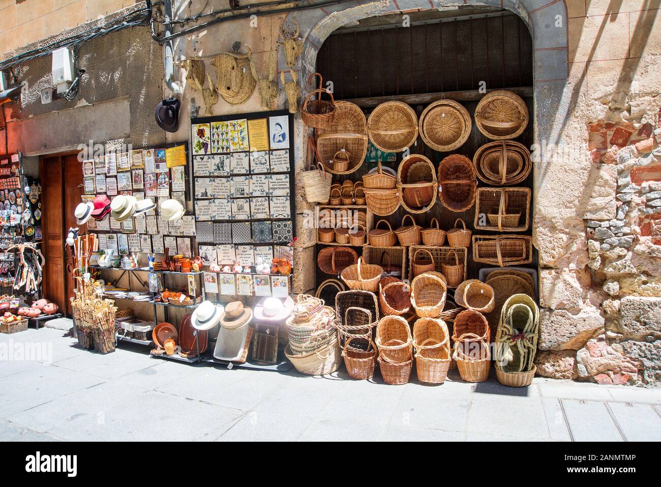 Segovia,Spain-June 10,2017: Wicker basktets,hats and  other articles hang outside a souvenir shop in a Segpvia,street Stock Photo
