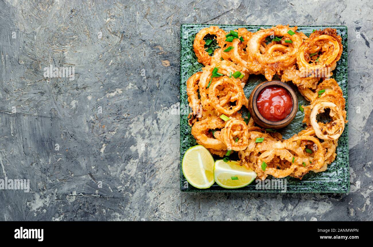 Crunchy deep fried squid rings in batter Stock Photo - Alamy