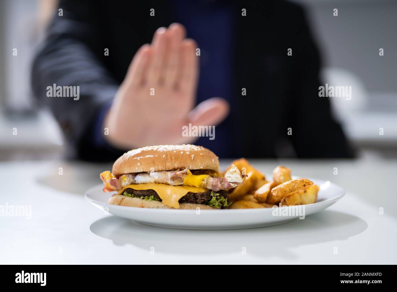 Close-up Of A Man's Hand Refusing To Eat Fest Food Burger Stock Photo