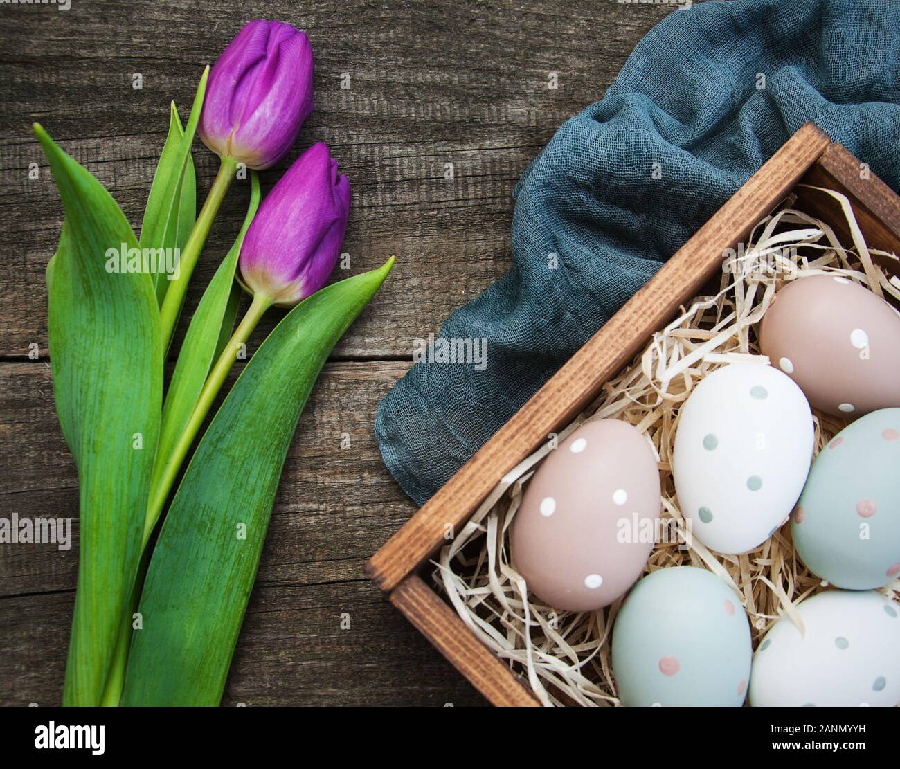Easter eggs and tulips on a old wooden background Stock Photo - Alamy