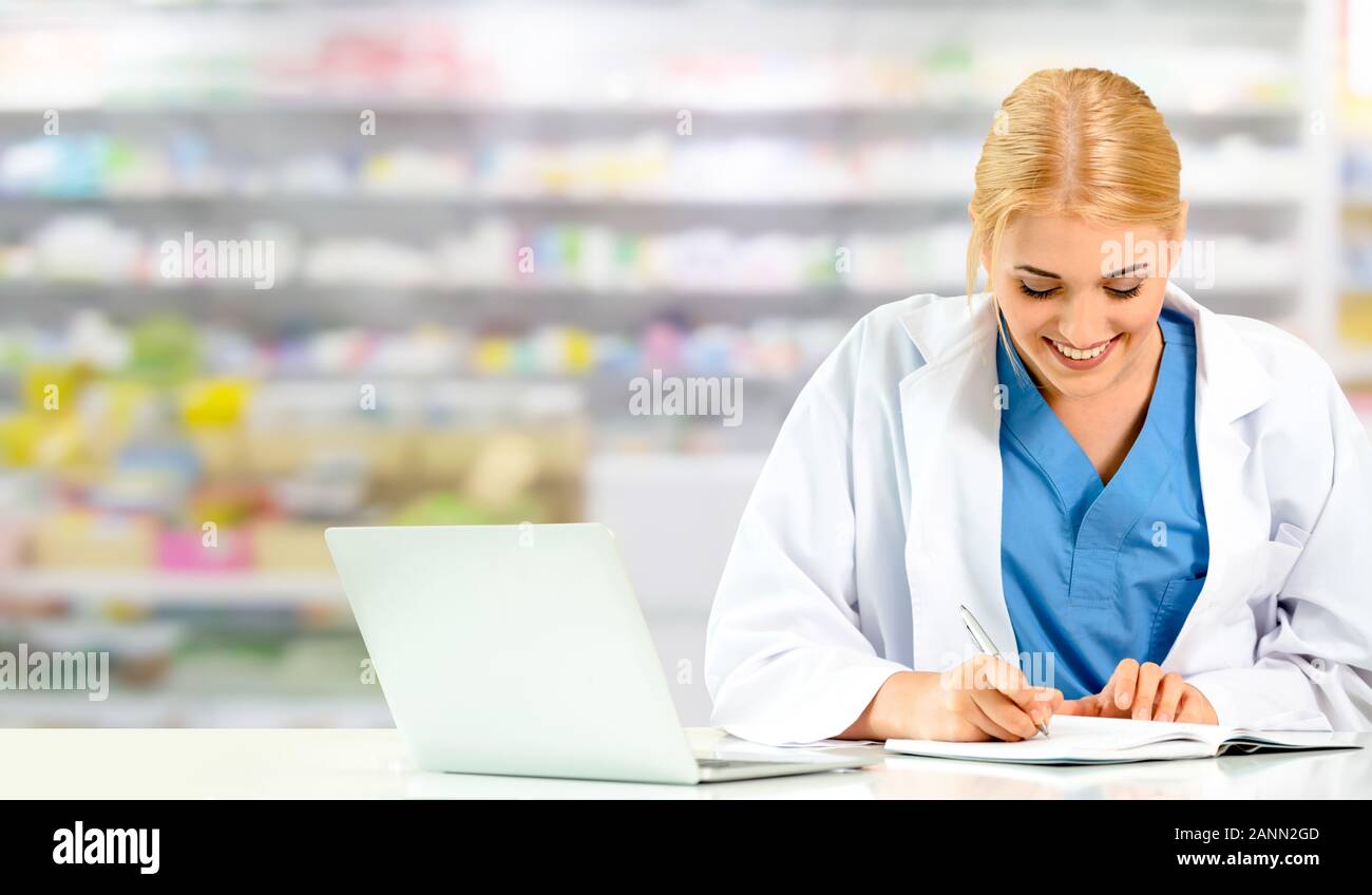 Pharmacist or doctor using laptop computer at the pharmacy room