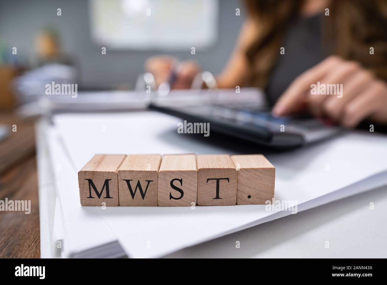 Businessperson Calculating MwSt. - Value-added tax in Germany Stock Photo