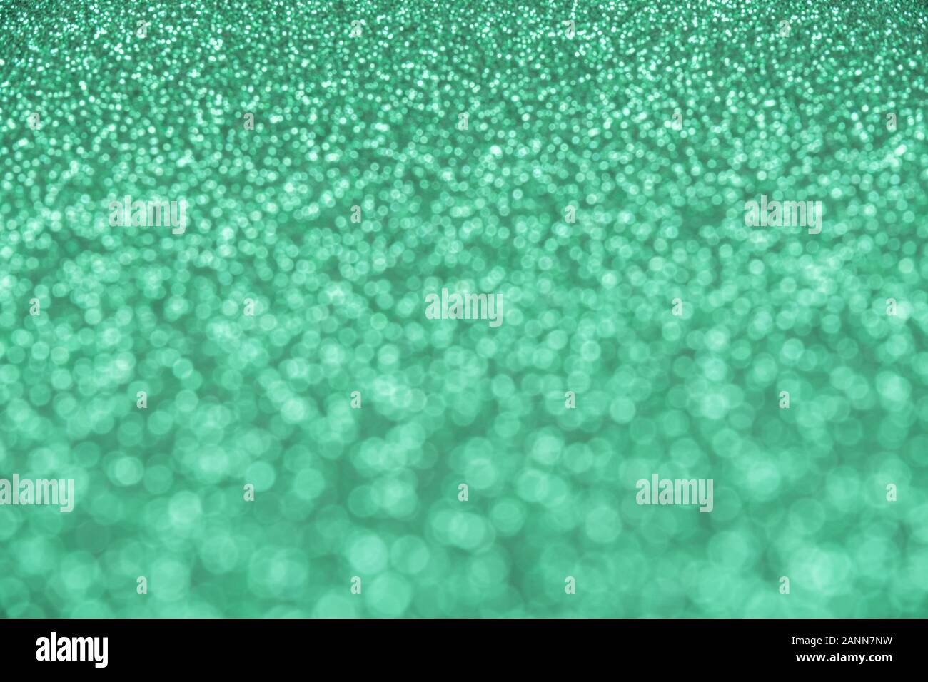 Abstract mint-colored background of blurred sequins and glitter Stock Photo