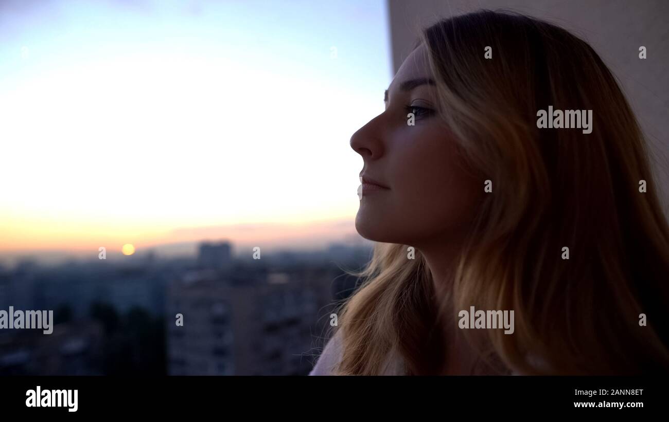 Woman watching sunset balcony hi-res stock photography and images - Alamy