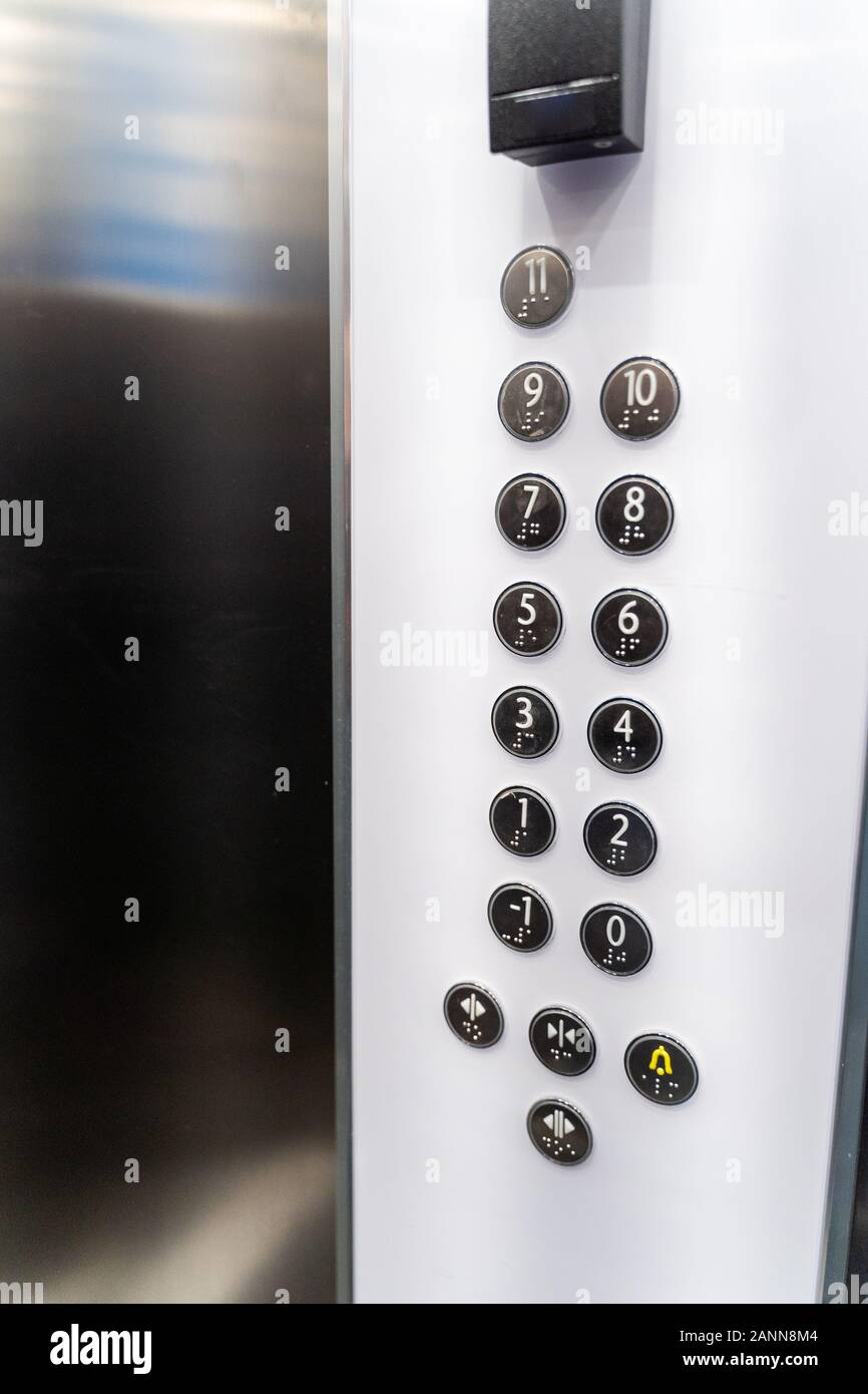Modern office building elevator buttons. Stainless steel and glass lift interior. Stock Photo