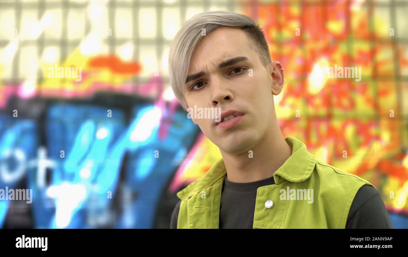 High school student with nose and ear piercing looking camera, urban style Stock Photo