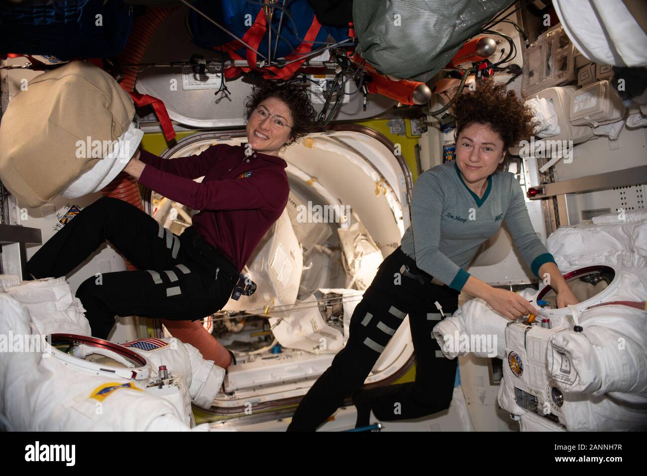 ISS - 15 Jan 2020 - NASA astronauts Christina Koch (left) and Jessica Meir work on their U.S. spacesuits ahead of a spacewalk they conducted to instal Stock Photo