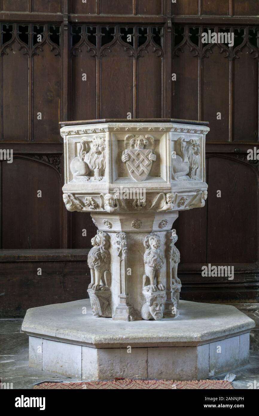 15th century font, decorated with figures of lions standing on human heads; church of St Mary, Helmingham, Suffolk Stock Photo