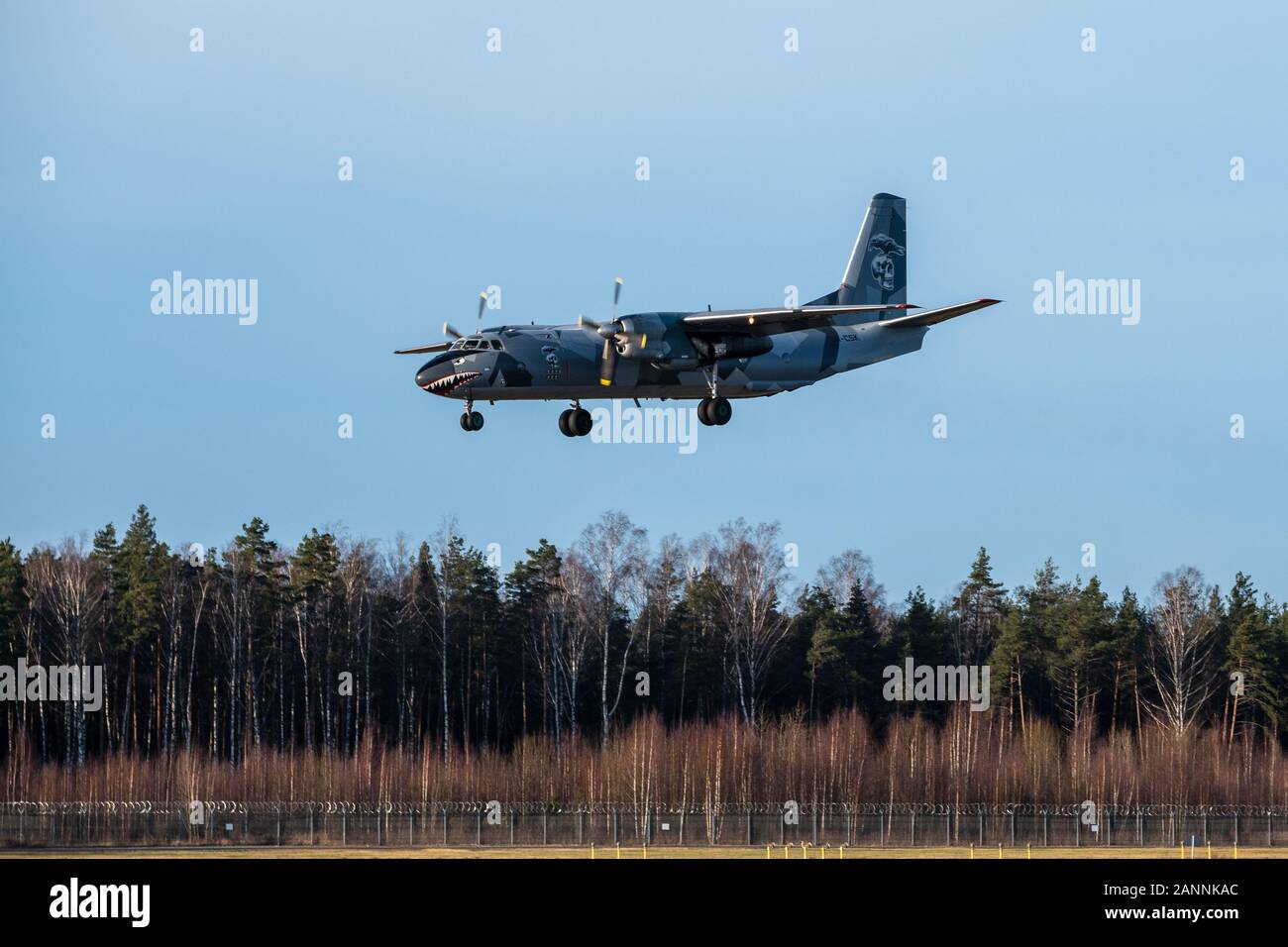 RIGA, LATVIA, JANUARY 17, 2020 - Ukranian airline Eleron cargo plane Antonov An-26B UR-CSK in special livery lands at Riga international Airport. The plane was used in Hollywood movie Expendables Stock Photo