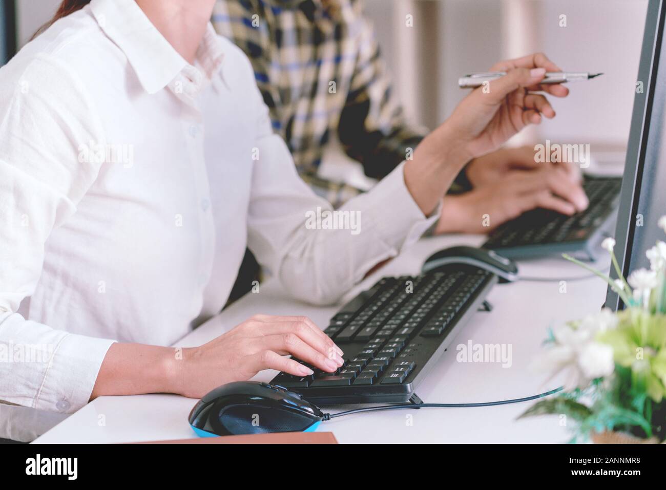 Pensive programmer working on desktop pc programming code technologies or website design at office Software Development Company Stock Photo