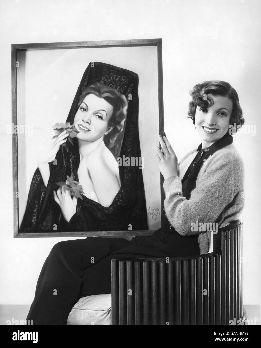CONCHITA MONTENEGRO 1934 Publicity Portrait with Painting of herself by Pin Up Artist ALBERTO VARGAS Fox Film Corporation Stock Photo