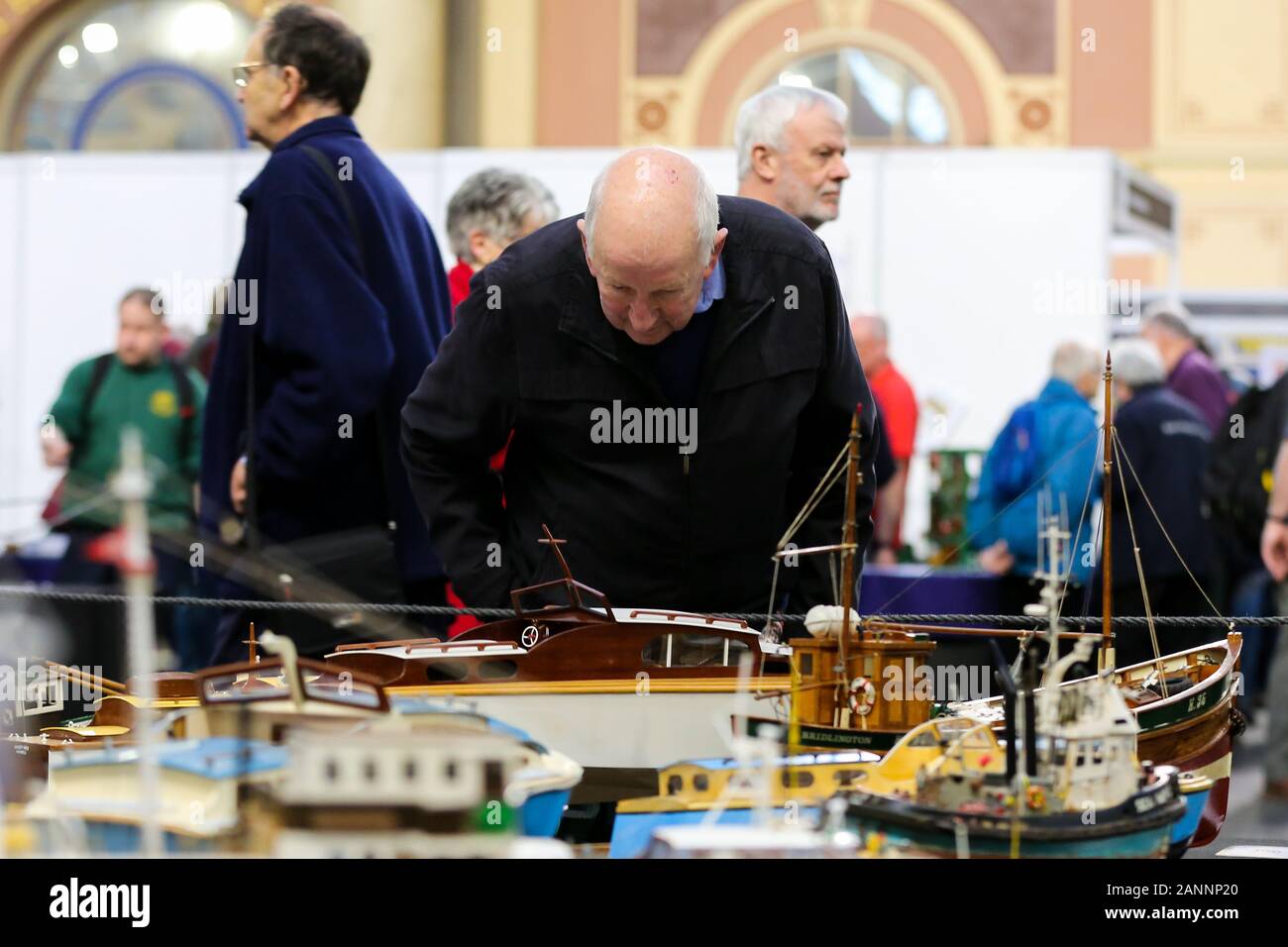A visitor views miniature ship models during the exhibition at