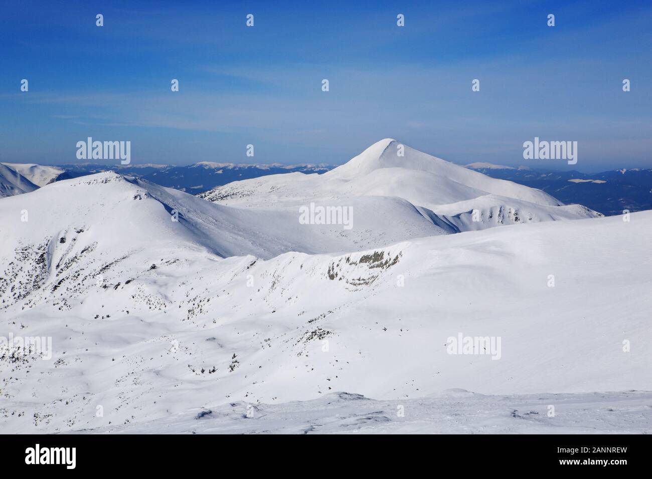 The mountains are covered with snow under a bright blue sky Stock Photo ...