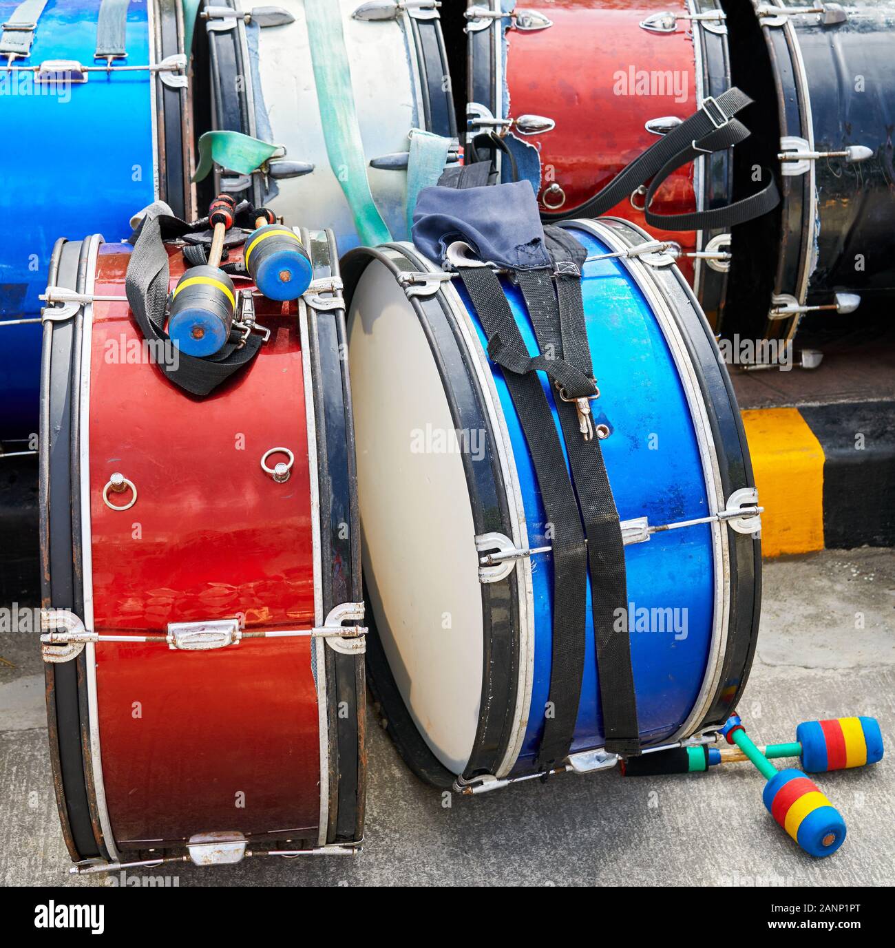 Isolated picture of metal drums with drumsticks laying on the ground after the parade at the Ati-Atihan Festival in Ibajay Town, Aklan, Philippines Stock Photo