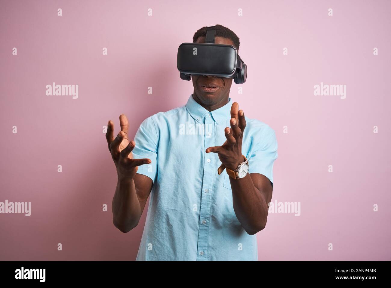 Young african american man playing virtual reality game using goggles ...