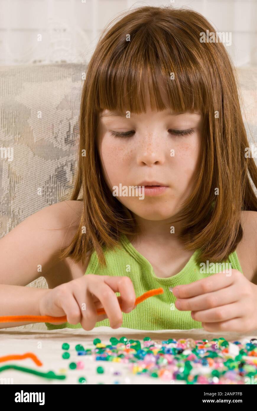 Young girl making bead bracelets Stock Photo Alamy
