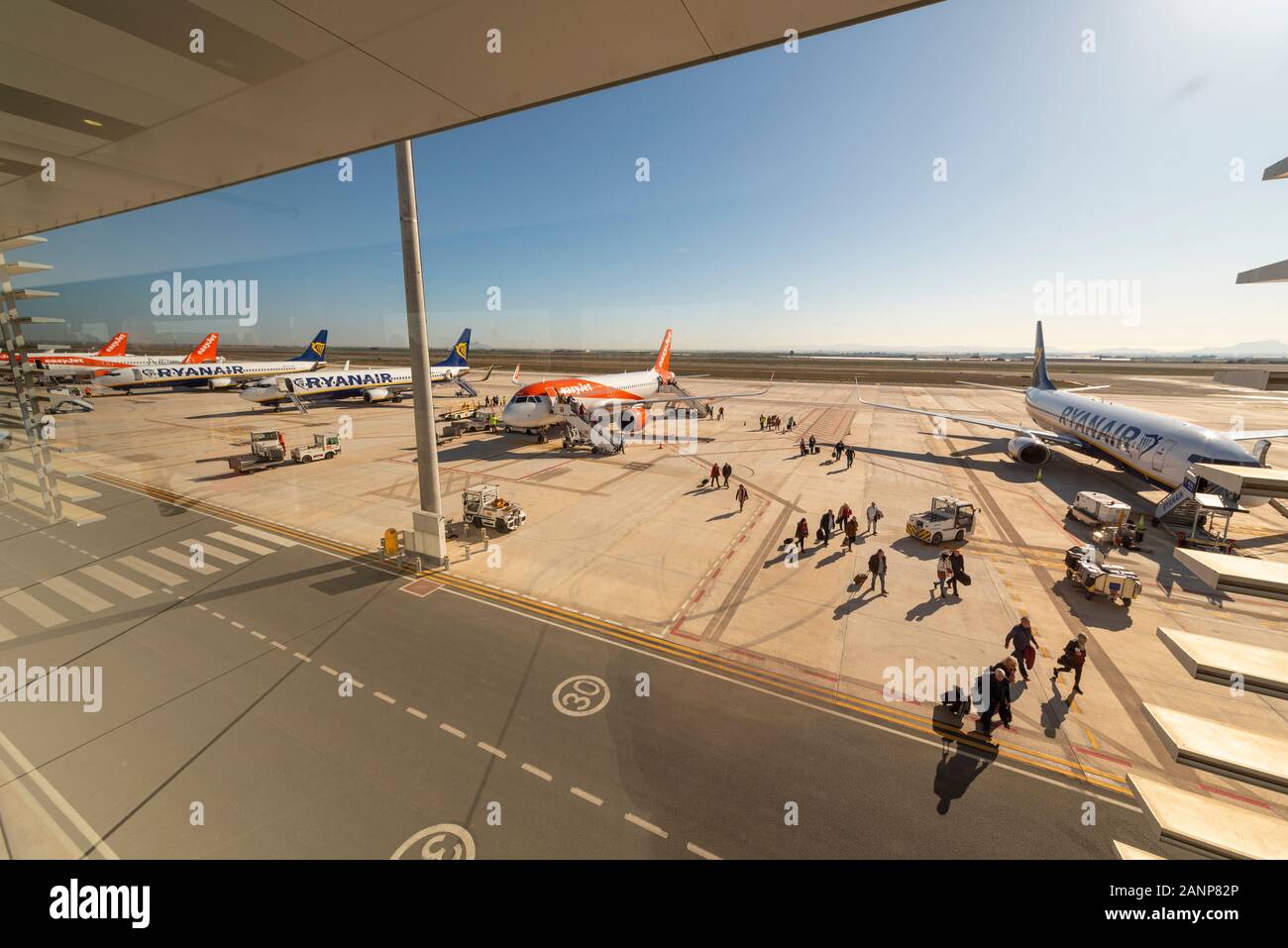 Region de Murcia International Airport, Corvera, Costa Calida, Spain, Europe. Busy with easyJet and Ryanair jet airliner planes. Passengers exiting Stock Photo