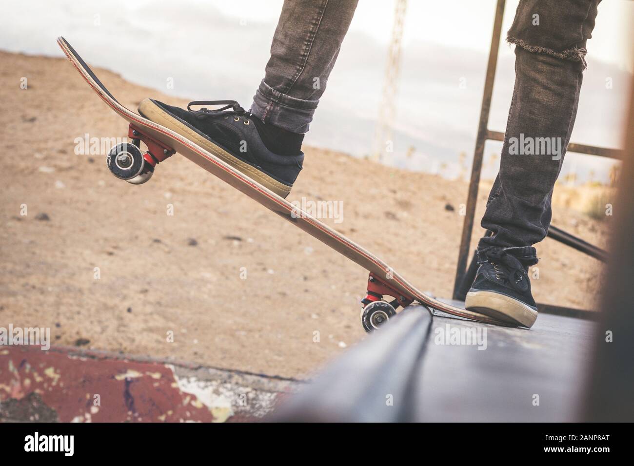 Close up view of teen's feet on a skateboard ready to start a ride over the