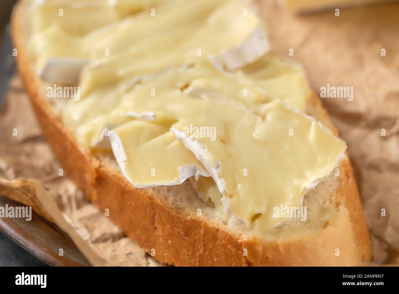Macro photo with shallow depth of field of bread with brie cheese Stock Photo