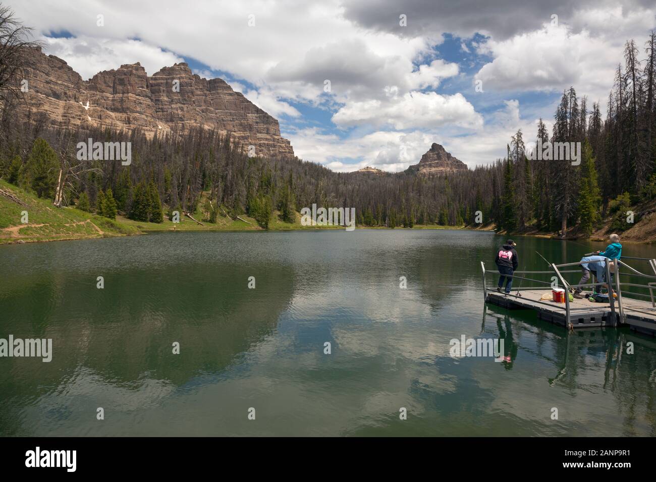 WY03974-00...WYOMING - Family fishing on the dock at the Wind River Lake Picnic Area located in the Bridger-Teton National Forest near Togwotee Pass. Stock Photo