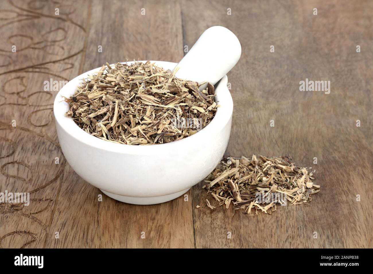 Nettle root herbin a mortar with pestle used in herbal medicine to