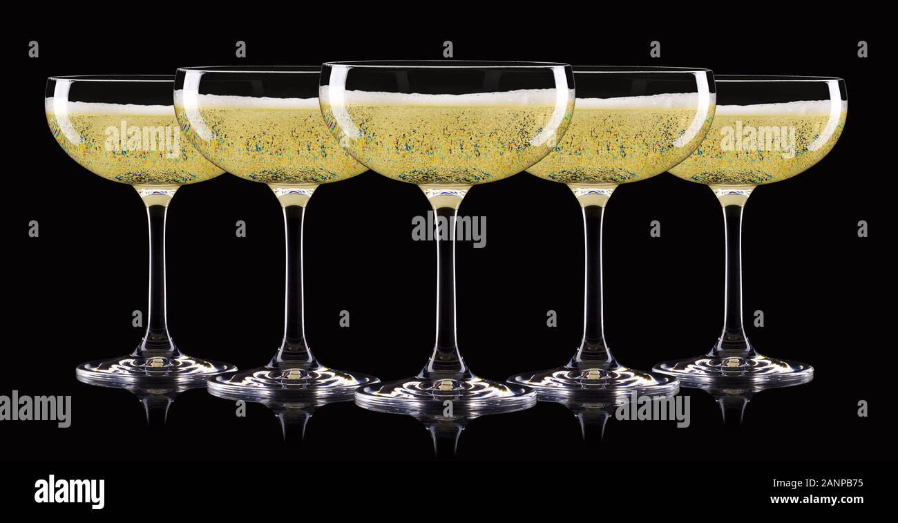 Set of luxury champagne glasses in a row isolated on a black background