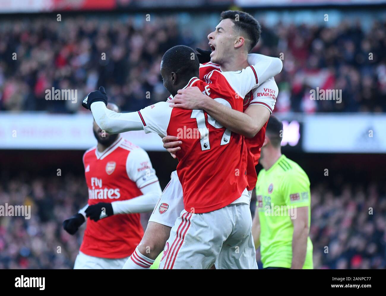 LONDON, ENGLAND - JANUARY 18, 2020: Gabriel Martinelli of Arsenal celebrates Nicolas Pepe of Arsenal after he scored a goal during the 2019/20 Premier League game between Arsenal FC and Sheffield United FC at Emirates Stadium. Stock Photo