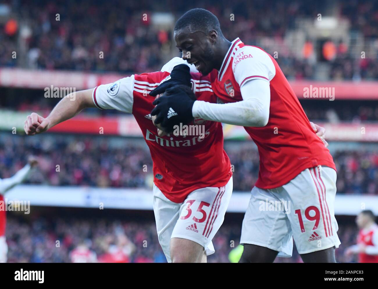 LONDON, ENGLAND - JANUARY 18, 2020: Gabriel Martinelli of Arsenal celebrates Nicolas Pepe of Arsenal after he scored a goal during the 2019/20 Premier League game between Arsenal FC and Sheffield United FC at Emirates Stadium. Stock Photo