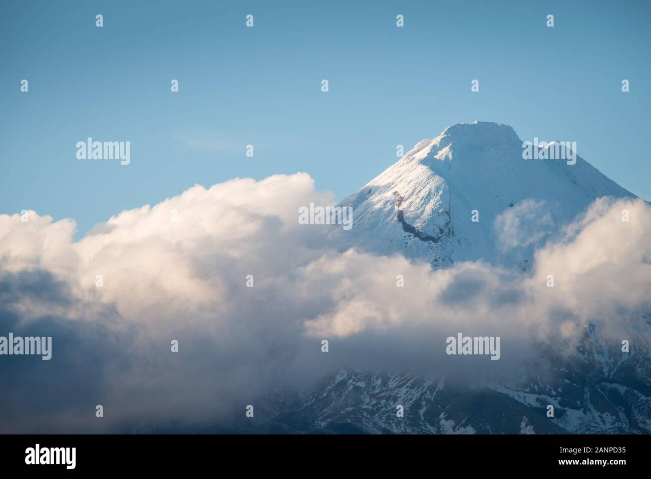 The Majestic Mt Taranaki rising above the clouds Stock Photo