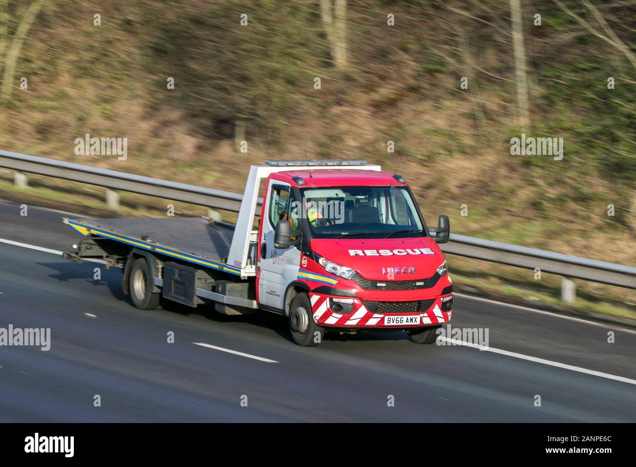 BV66AWX Iveco breakdown recovery truck driving on the M6 motorway near Preston in Lancashire, UK Stock Photo