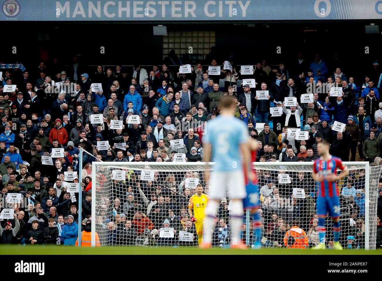 Football fans hold up anti-VAR signs in the stands during the Premier ...
