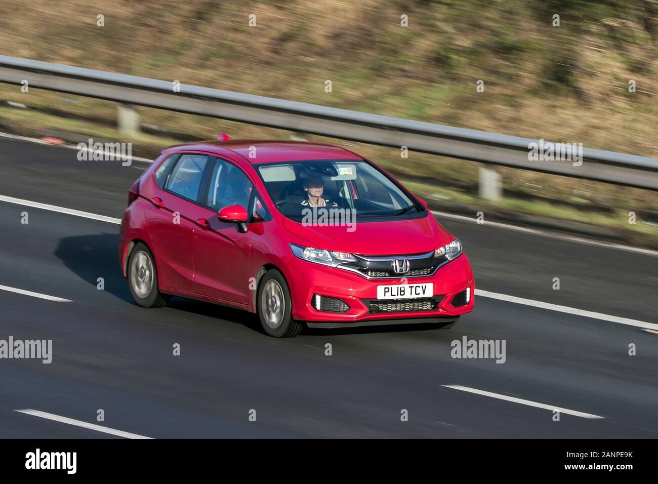 2018 Honda Jazz Se I-Vtec Red car Petrol driving on the M6 motorway near Preston in Lancashire, UK Stock Photo