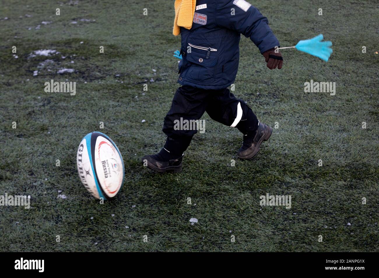 A boy plays with Rugby ball Stock Photo Alamy