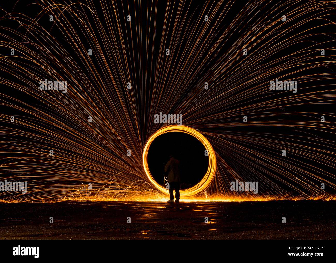 Steel wool painting with light in darkness spark effect and reflections