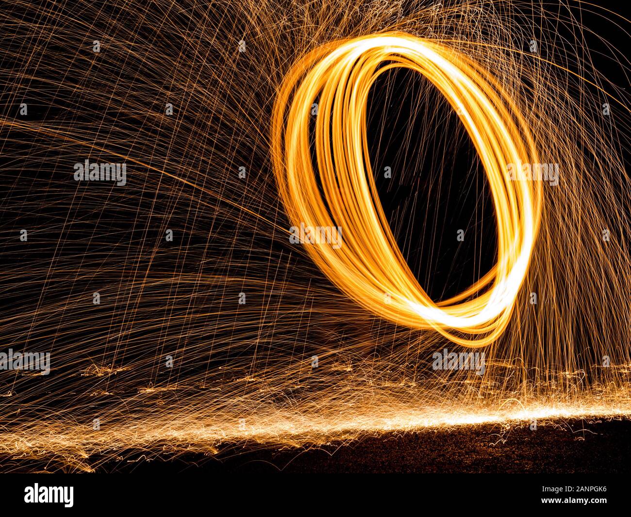Steel wool painting with light in darkness spark effect Stock Photo