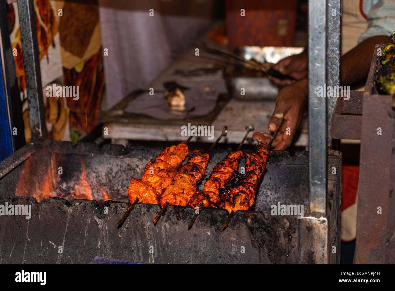 Street food/Traditional Grilled tandoori of  assorted meats with charcoal and fire on skewers Stock Photo