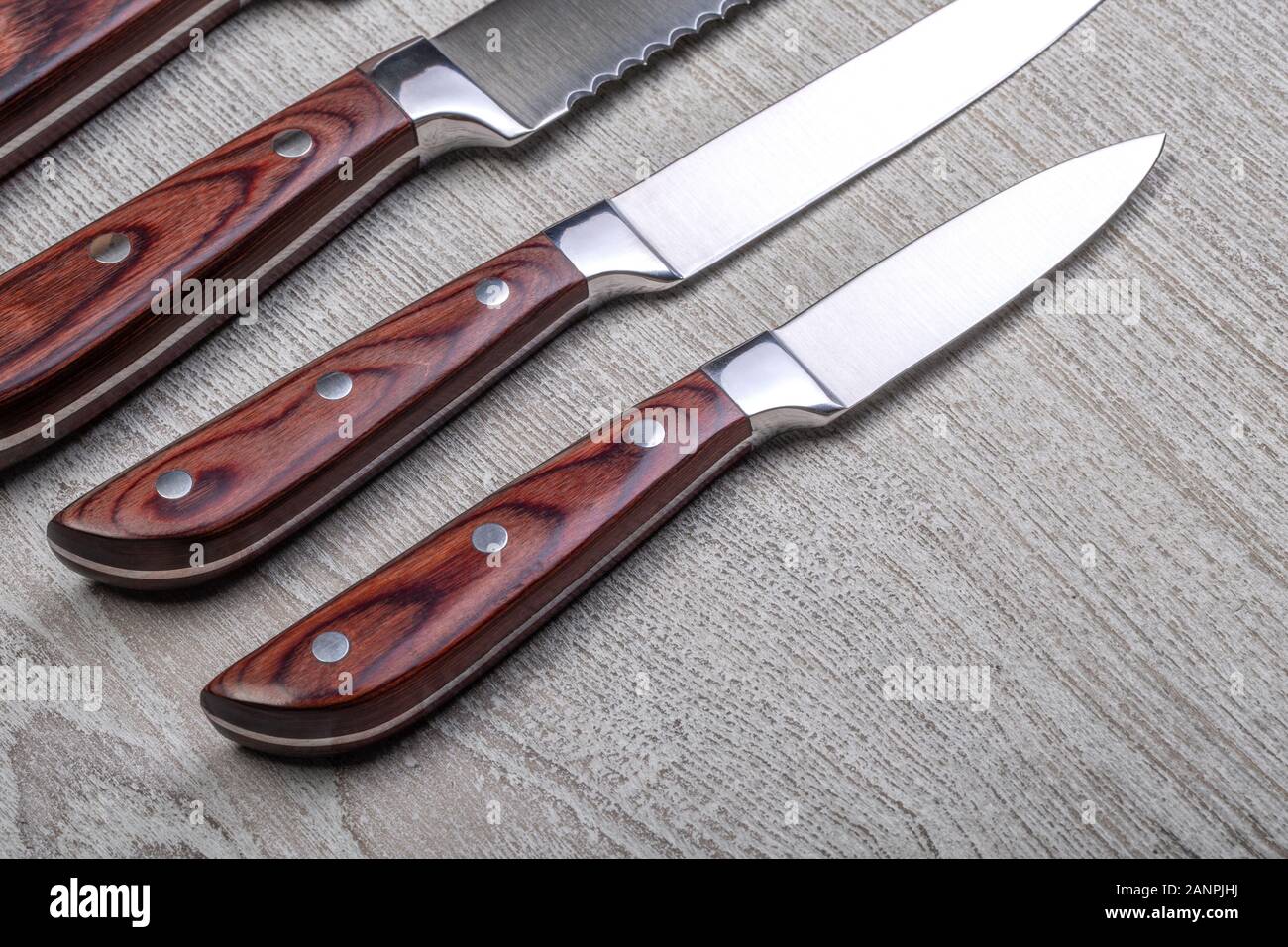 https://c8.alamy.com/comp/2ANPJHJ/knives-with-a-wooden-handlemade-of-steel-close-up-2ANPJHJ.jpg
