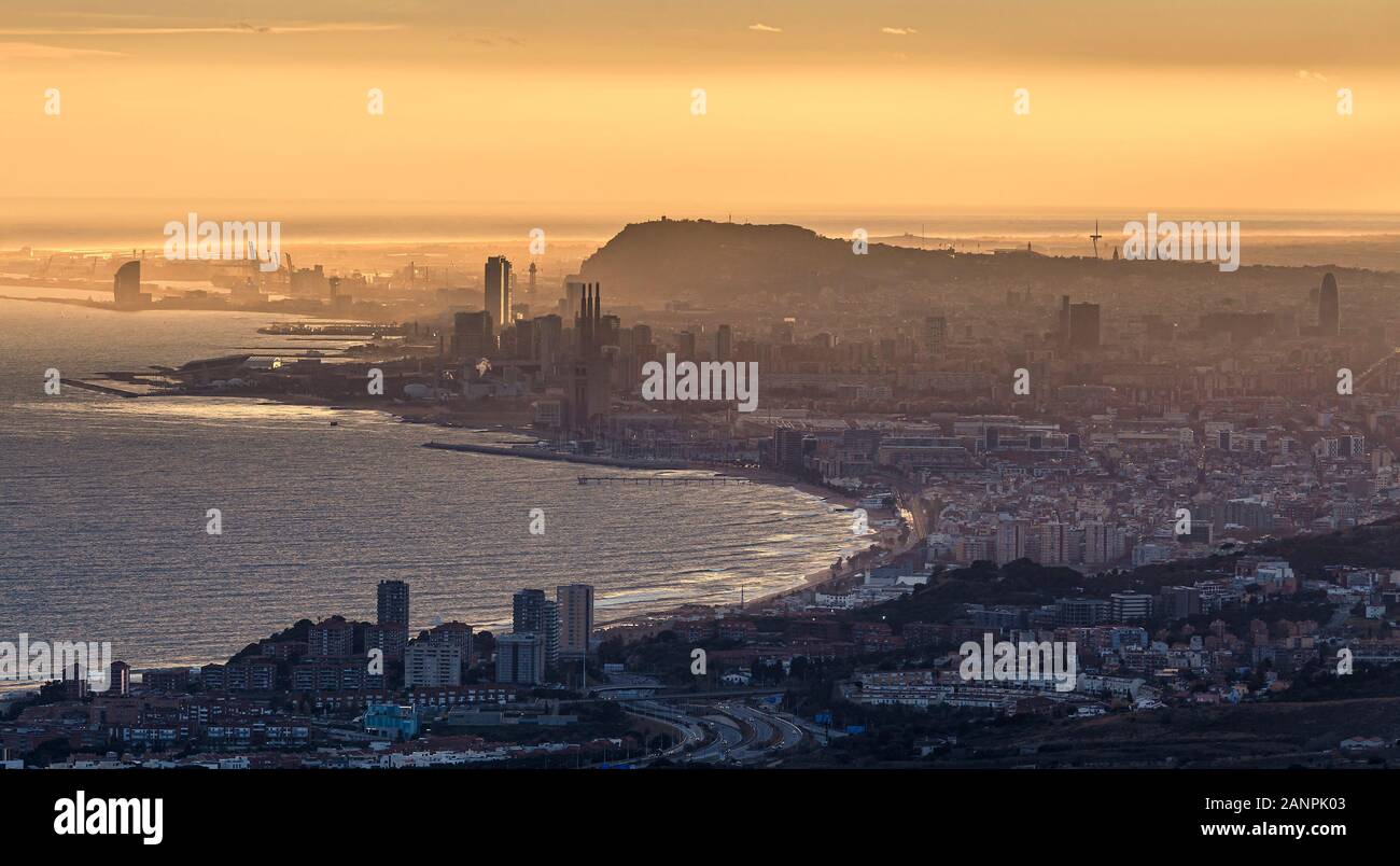 Misty Distant Aerial View of Barcelona at Golden Hour Stock Photo