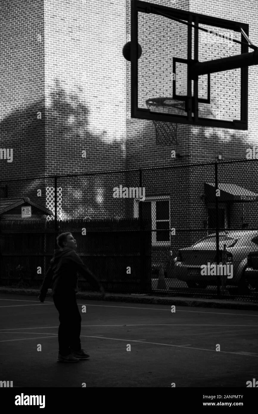 Kid playing basketball Stock Photo
