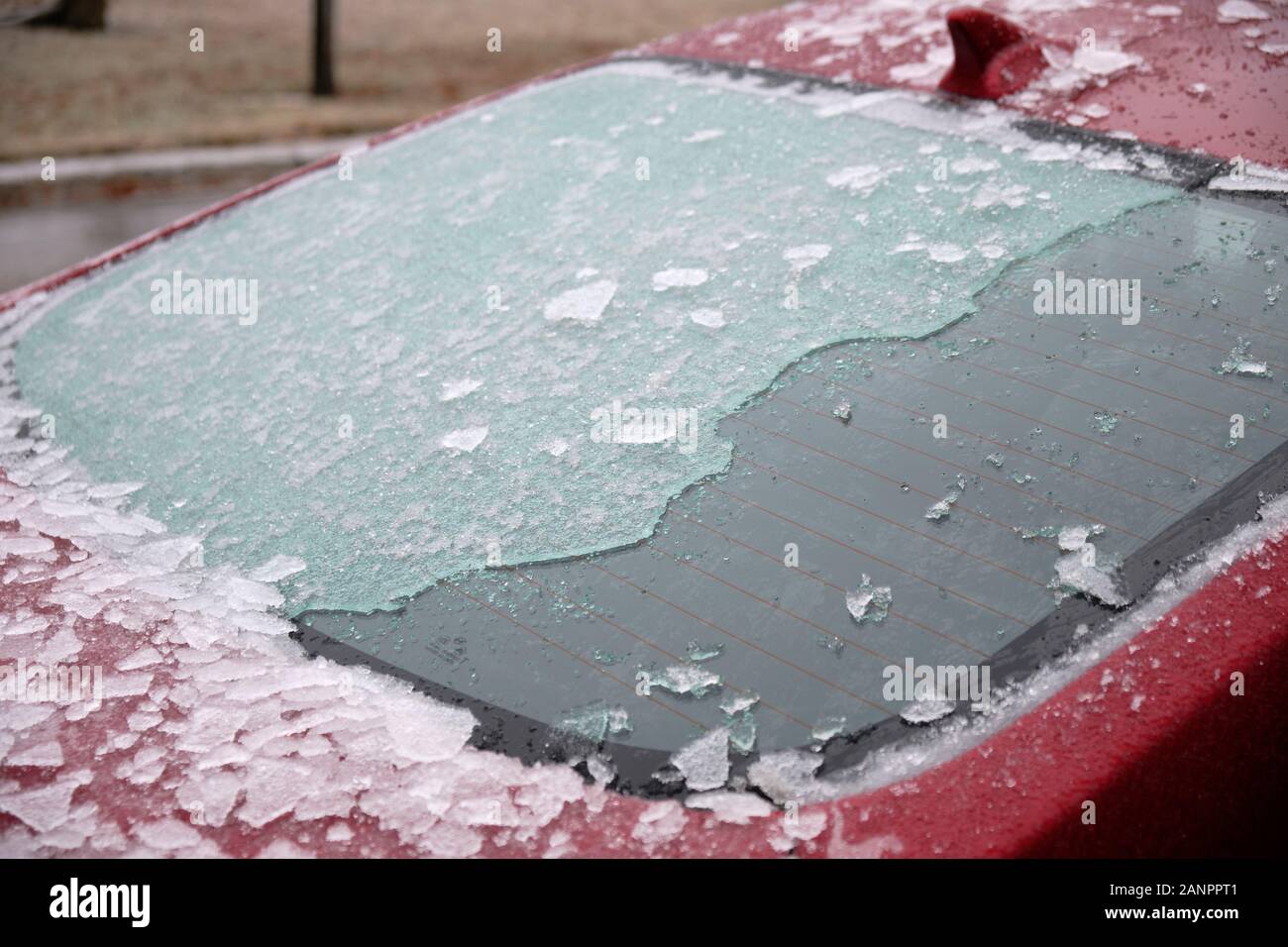 Car windshield covered in ice falling freezing rain storm partially scrapped Stock Photo