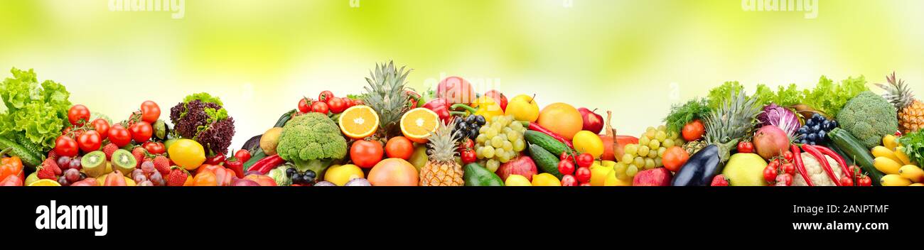 Composition variety fresh fruits and vegetables on green background. Glass skinali. Stock Photo