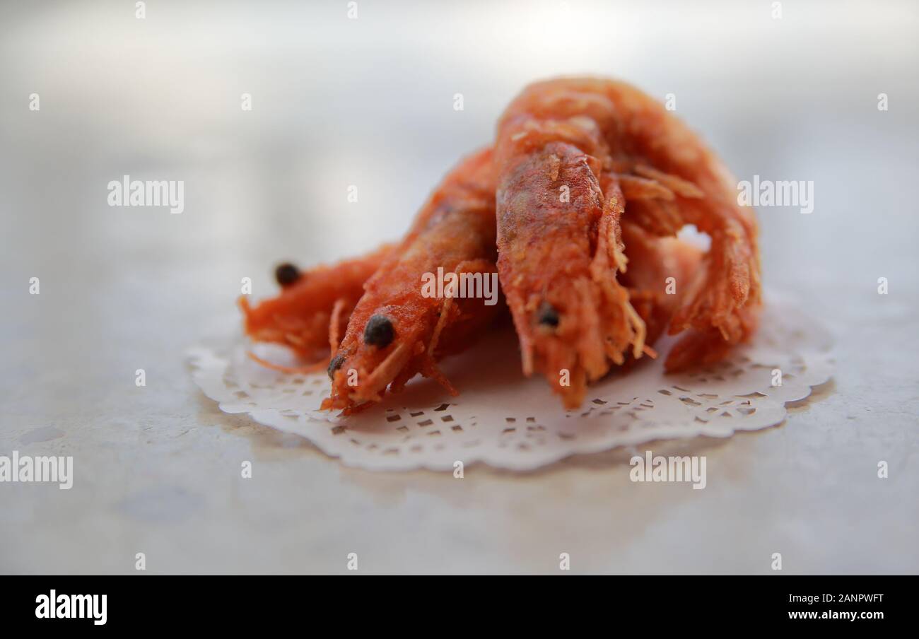 Cooked / prepared / fried breaded shrimps / prawns close up on table. Stock Photo