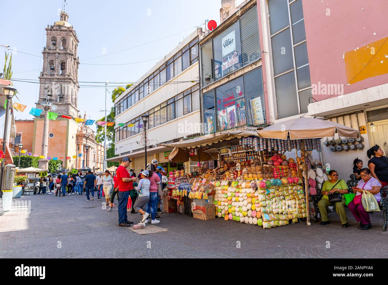 Celaya, Guanajuato, Mexico - November 24, 2019: Tourists and Locals shopping at street market along Gongora St. with the Immaculate Conception Cathedr Stock Photo