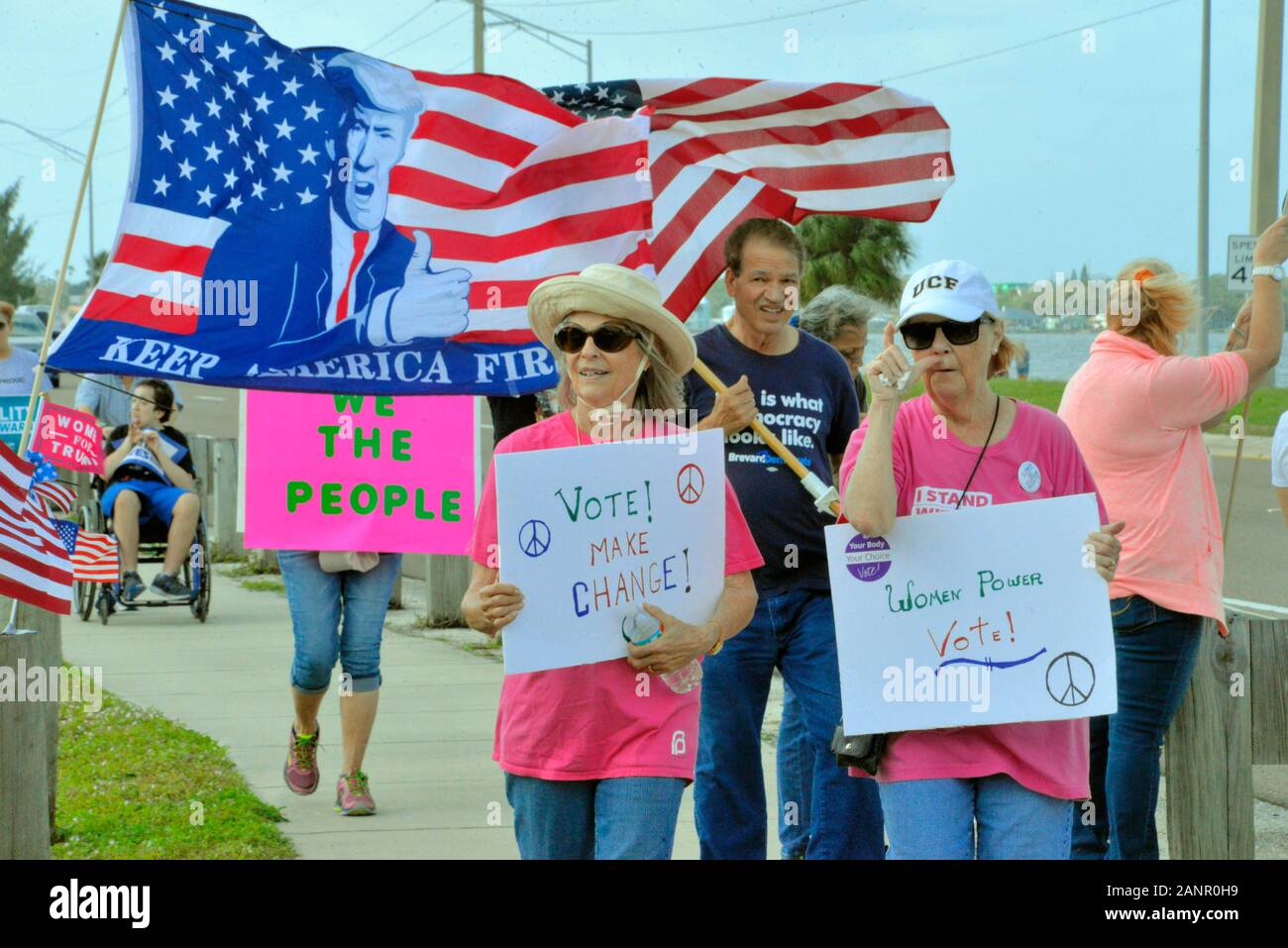 Melbourne. Florida. USA. January 18, 2020. With bull horns, American Flags and homemade signs two groups of protesters held demonstrations along the same highway. The American Civil Liberties Union (ACLU) had several monitors watching the event along the Eau Gallie Causeway. Trump for President 2020 and the 2020 Woman’s March at times intermingled with each other, but for the most part where civil with each other. Photo Credit Julian Leek / Alamy Live News Stock Photo